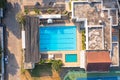 Aerial view of swimming pool on rooftop of hotel apartment building in sport club, urban city view. Relaxing in summer season in
