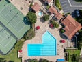 Aerial view swimming pool and tennis court in middle class neighborhood community, South California