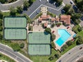 Aerial view swimming pool and tennis court in middle class neighborhood community, South California