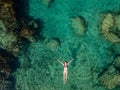 Aerial view of swimming woman in clear water of Mediterranean Sea Royalty Free Stock Photo