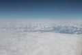 An aerial view of the Swiss part of the Alps, with peaks higher than the cloudscape covering the valleys