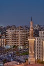 Aerial view of Tahrir Square in Cairo at night, featuring a brightly-lit Minaret of a mosque.