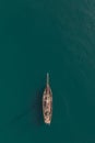 Aerial view of a tall mast sailing ship on a calm turquoise ocean