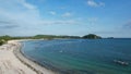 Aerial view of Tanjung Aan, Tropical island with sandy beach and turquoise ocean with waves. Lombok. Indonesia, Mach 22, 2022 Royalty Free Stock Photo