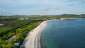 Aerial view of Tanjung Aan, Tropical island with sandy beach and turquoise ocean with waves. Lombok. Indonesia, Mach 22, 2022 Royalty Free Stock Photo