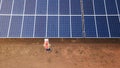 Technician checking the panel in solar power station panels Royalty Free Stock Photo