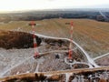 Aerial view telecommunication towers of mobile communication on the background of green field is covered with white snow. Royalty Free Stock Photo