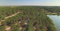 Aerial view of temperate coniferous forest and lake nearby in Bessarabia