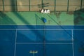 Aerial view of a tennis court bathed in warm winter sunlight, with scattered tennis balls Royalty Free Stock Photo