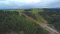Aerial view of the terrain covered by lush green vegetation. Clip. Beautiful landscape with forest and fields with green Royalty Free Stock Photo