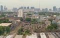 Aerial view of Thai local old classic train or tram on railway in Hua Lamphong terminal station with skyscraper buildings in urban