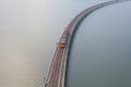 Aerial view of Thai local train on railway bridge at Pa Sak Jolasid Dam, the biggest reservoir in central Thailand, in Lopburi