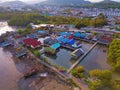 Aerial view of Thai traditional Asian fishing village near sea beach. Floating houses at sunset background in rural area, Phuket Royalty Free Stock Photo