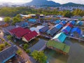 Aerial view of Thai traditional Asian fishing village near sea beach. Floating houses at sunset background in rural area, Phuket Royalty Free Stock Photo