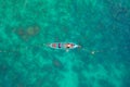 Aerial View of Thai traditional longtail fishing boats in the tropical sea in phuket thailand