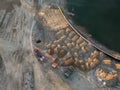 Aerial view of three multi-colored dump tip trucks unloading in Royalty Free Stock Photo