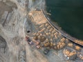 Aerial view of three multi-colored dump tip trucks unloading in Royalty Free Stock Photo