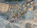 Aerial view of three multi-colored dump tip trucks unloading in Royalty Free Stock Photo