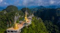 Aerial view Tiger Cave Temple, Buddha on the top Mountain with blue sky of Wat Tham Seua, Krabi,Thailand