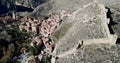 Aerial view of tiled housetops and defensive wall of medieval town Albarracin, Spain