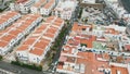 Aerial view. Tiled roofs of white resort houses off the coast of the Atlantic. The coastal city of Agaete, Gran Canaria.