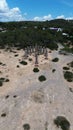 Aerial view of Time and Space rock columns sculpture on the sandy beach on the backdrop of trees Royalty Free Stock Photo