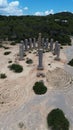 Aerial view of Time and Space rock columns sculpture on the sandy beach on the backdrop of trees Royalty Free Stock Photo