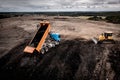 Aerial view of a tipper truck with raised trailer on a household waste dump