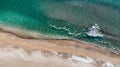 Aerial view to beautiful tropical sandy beach and soft foam waves, blue sea. Ocean water nature, beach relax. Summer sea vacation Royalty Free Stock Photo
