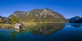 Aerial view to boathouse at lake plansee in fall mood with great reflections