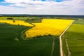 Aerial view to countryside with road, green and yellow agricultural fields, forests Royalty Free Stock Photo