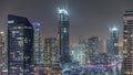 Aerial view to Dubai marina skyscrapers around canal with floating boats night timelapse Royalty Free Stock Photo