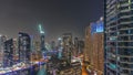 Aerial view to Dubai marina skyscrapers around canal with floating boats night timelapse Royalty Free Stock Photo