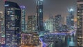 Aerial view to Dubai marina skyscrapers around canal with floating boats night timelapse Royalty Free Stock Photo