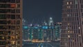 Aerial view to Dubai marina skyscrapers with construction site and Palm Jumeirah Island on background night timelapse. Royalty Free Stock Photo