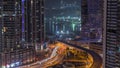 Aerial view to Dubai marina skyscrapers with construction site and Palm Jumeirah Island on background night timelapse. Royalty Free Stock Photo