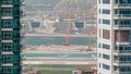Aerial view to Dubai marina skyscrapers with construction site and Palm Jumeirah Island on background timelapse. Royalty Free Stock Photo