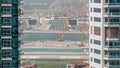 Aerial view to Dubai marina skyscrapers with construction site and Palm Jumeirah Island on background timelapse. Royalty Free Stock Photo