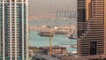 Aerial view to Dubai marina skyscrapers with construction site and Palm Jumeirah Island on background timelapse. Royalty Free Stock Photo