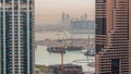 Aerial view to Dubai marina skyscrapers with construction site and Palm Jumeirah Island on background timelapse. Royalty Free Stock Photo