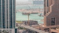 Aerial view to Dubai marina skyscrapers with construction site and Palm Jumeirah Island on background timelapse. Royalty Free Stock Photo