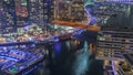 Aerial view to Dubai marina skyscrapers around canal with floating boats night timelapse Royalty Free Stock Photo