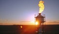 Aerial view to gas flare stack of petroleum refineries sunset background, flare pit tower Royalty Free Stock Photo