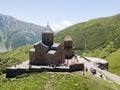 Aerial view to Gergeti Trinity Church or Tsminda Sameba, Holy Trinity Church near the village of Gergeti in Georgia, under Mount Royalty Free Stock Photo