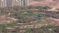 Aerial view to Golf course with green lawn and lakes, villa houses behind it timelapse. Royalty Free Stock Photo