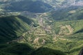 Aerial view to hilly countryside with settlement