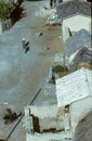 aerial view to inka village in the valley of Urubamba with old woman riding on a donkey