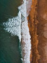 Aerial view to ocean waves and red sand beach Royalty Free Stock Photo