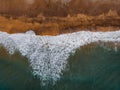 Aerial view to ocean waves and red sand beach Royalty Free Stock Photo