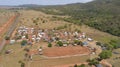 Aerial view to rodeo grounds, subsequent residential area and forested mountains in Bom Jardim, Mato Grosso, Brazil